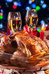 Baked or roasted whole chicken on Christmas table