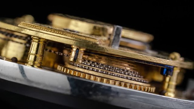 Working mechanism of a vintage watch close up . Black background. Time lapse