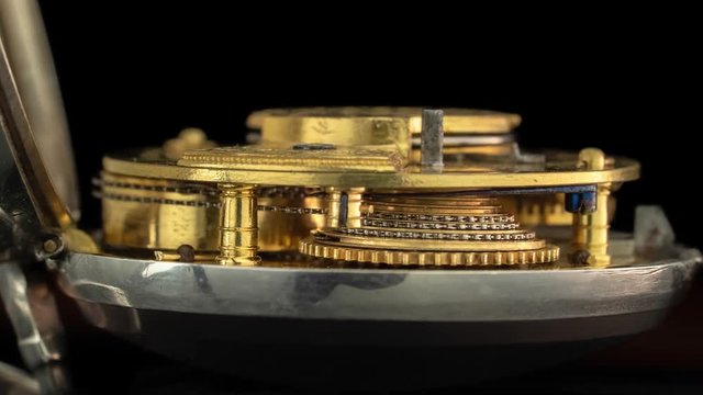 Working mechanism of a vintage watch close up . Black background. Time lapse