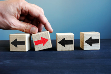 Innovation in the business. Cubes with arrows and one with another direction. Uniqueness,...