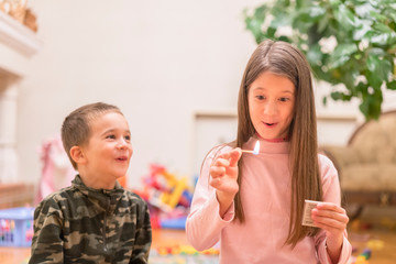 Small children playing with fire at home. A child plays with matches in the foreground a burning match, a child and matches, a fire, dangerous