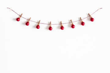 Christmas composition. Garland made of red balls on white background. Christmas, winter, new year...