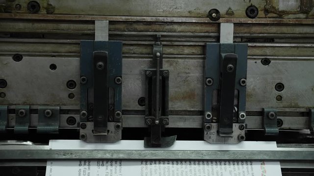 The work of the machine mechanism on the professional production of printed products.