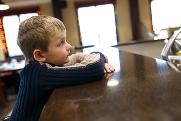 Boy sitting at bar