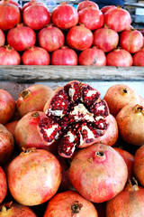 Close-up of Punica, Pomegranate. Sale of fresh of ripe juicy pomegranates, farmer's bazaar, open showcases of market.