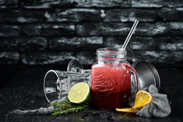Fresh blended cocktail of currant, blackberry and blueberries. On a wooden background. Top view....