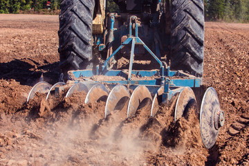 Tractor with soil preparation The tractor is preparing the soil for planting.