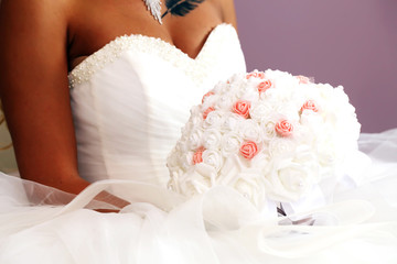 Fototapeta premium beautiful bride in white dress with boutonniere in hands,close up