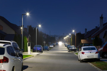 small city street with modern LED streetlights at night
