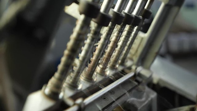 Machine for stitching book pages with threads in professional typography.