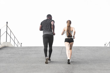 happy young couple afro-american man and european woman running together. A loving couple is run, engaged in sports, family values