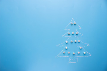 Christmas tree draws on the blue background