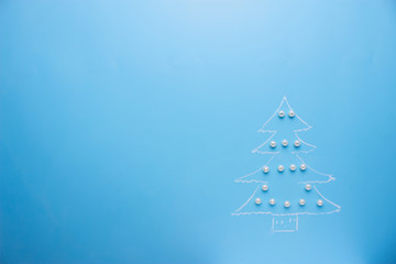 Christmas tree draws on the blue background