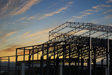 beam and roof frame of new new factory during sunset