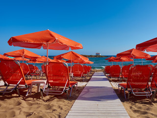 orange loungers on the sea beach