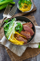 Hoisin duck with mango, spring onion, rocket lettuce salad and rice - top view