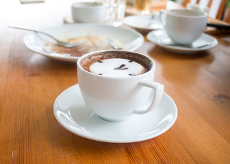 Close up of Cup of hot latte art coffee on wooden table
