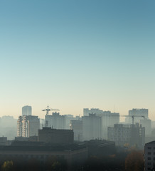 Fototapeta na wymiar Cityscape at sunrise, building rooftops, bird view