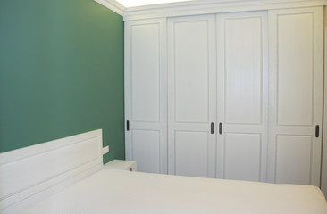 Large white bed in the bedroom. The interior of the bedroom.