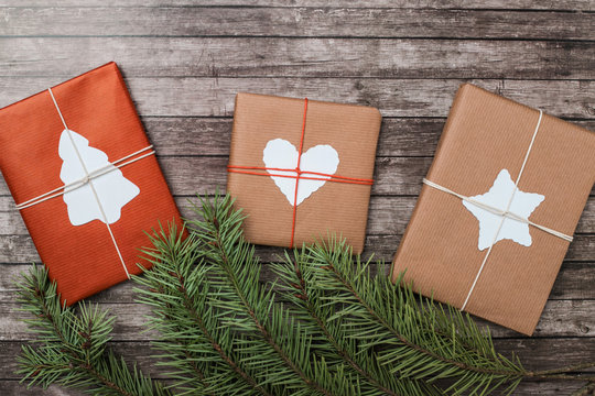 Christmas gifts with fir-tree on wooden background. - Powered by Adobe