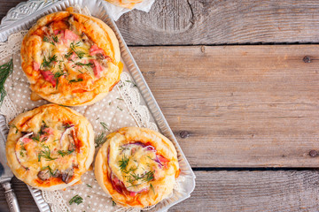 Mini pizza with sausage, top view, horizontal, copy space