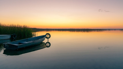 The boat on the lake in the sunsetlight. Naroch, Belarus
