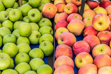food concept fruits apples board between red and green on market stall background texture