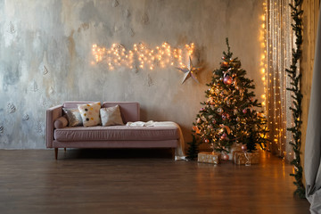 Dark loft living room decorated for Christmas with tree and lights