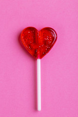 Red sweet tasty lollipop in shape of heart