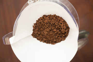 Drip coffee with paper filter tool on wood background