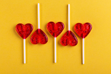 Five red sweet tasty lollipops in shape of heart