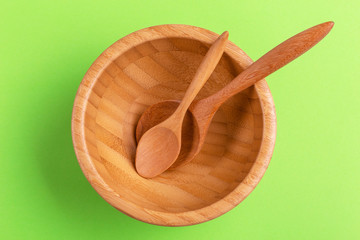 Empty wooden rustic bowl with two spoons