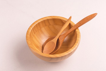 Empty wooden rustic bowl with two spoons