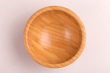 Empty wooden rustic bowl on clean white background