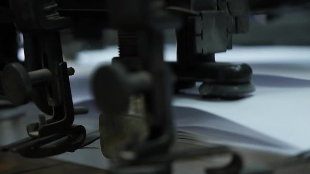 Move the paper sheets in the printing press suction cups. Professional printing machine in the typography.