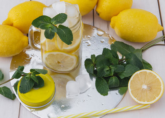 lemon juice and ice mint on a white wooden table