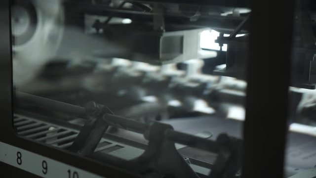 The work of a professional printing press in the printing house. Offset printing machine.