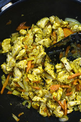 Cooking chicken and vegetables in a wok