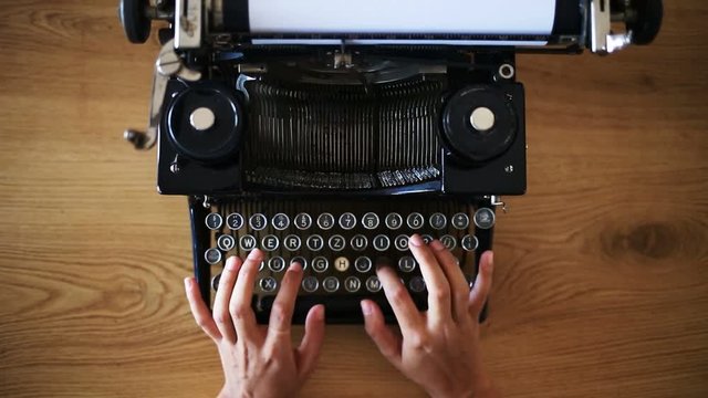 High angle view of writer prints on vintage typewriter