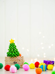 A Christmas tree filled with gifts and colorful balls close up shot