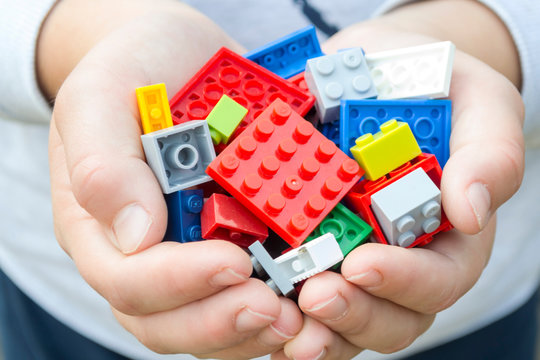 Colored Toy Bricks  In Child Hands.