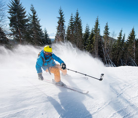 Action shot of professional skier taking selfies photo with a camera on selfie stick while skiing...