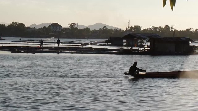 boy earns living as fisherman in a lake using boat