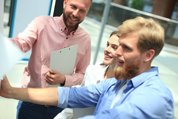 Group of young business people and designers in smart casual wear. They working on new project.