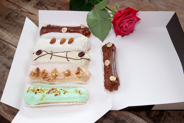delicious eclairs in a white box