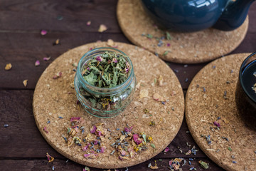 Dry Herbal tea in a glass jar on a wooden table. selective focus.