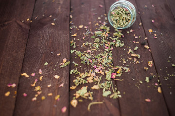 Obraz na płótnie Canvas Dry Herbal tea in a glass jar on a wooden table. selective focus.