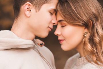 Happy teen boy and girl 16-18 year old posing together with closed eyes closeup. Love concept. Togetherness.