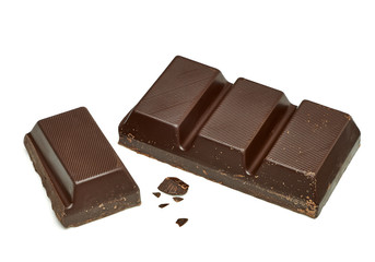 Broken or cracked dark chocolate bars, chips or pieces isolated on white background