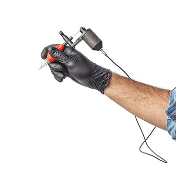 Tattooist hands in black gloves with tattoo machine isolated on white background.
